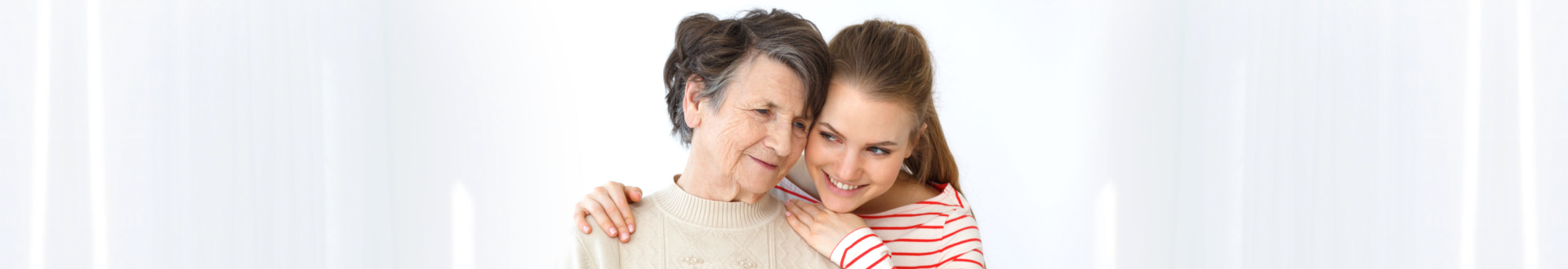 caregiver and three elders smiling