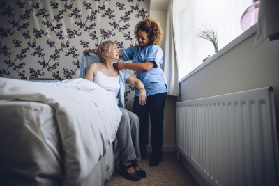 caregiver assisting an elder