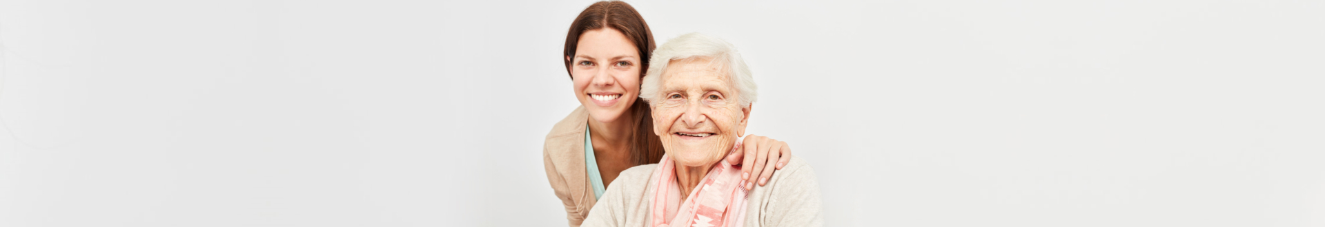 caregiver and elderly patient smiling