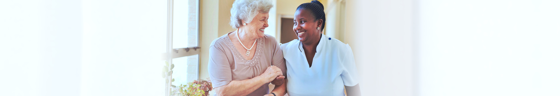 caregiver holding the hands of elderly patient